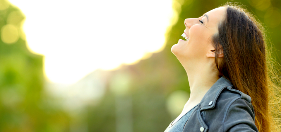 Woman smiling sun shining on her