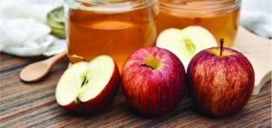 Apples with apple cider vinegar in mason jars