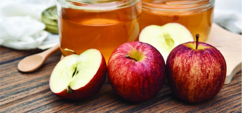 Apples with apple cider vinegar in mason jars