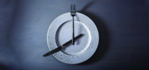 fancy plate with a knife and fork forming the hands of a clock